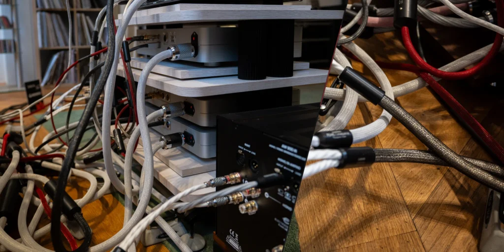 Audio cable routing around components in a hi-fi system.